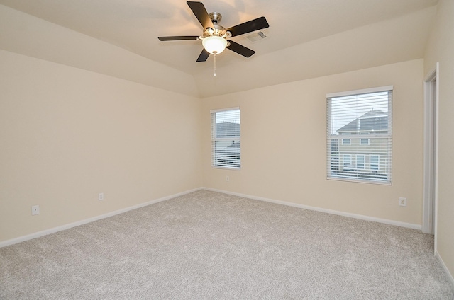 carpeted empty room with vaulted ceiling and ceiling fan