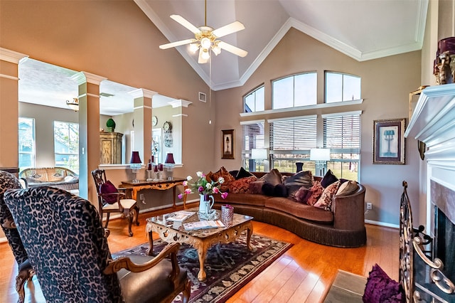 living room featuring ornamental molding, a high end fireplace, wood-type flooring, and plenty of natural light