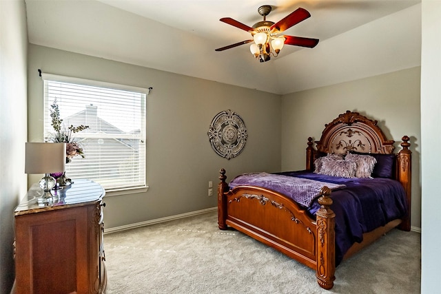 carpeted bedroom featuring multiple windows, lofted ceiling, and ceiling fan