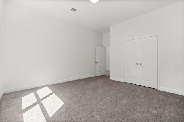 unfurnished bedroom with a closet and carpet