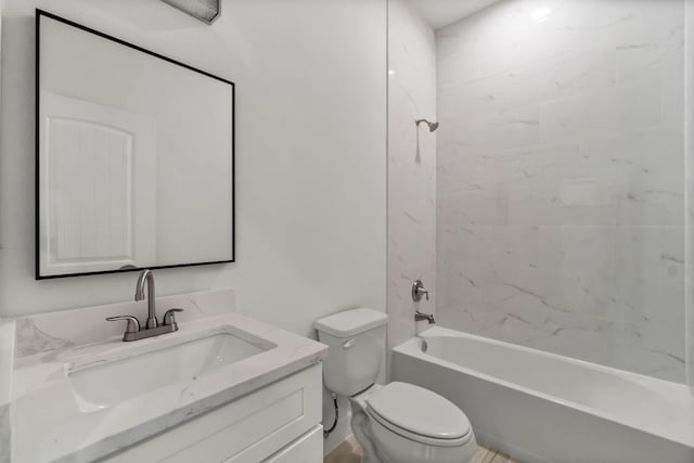 full bathroom with vanity, toilet, and tiled shower / bath combo