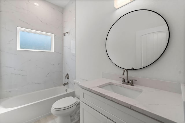 full bathroom with tiled shower / bath, vanity, and toilet