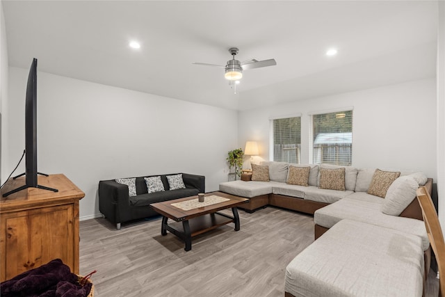 living room with ceiling fan and light hardwood / wood-style flooring