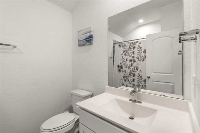 bathroom featuring vanity, vaulted ceiling, toilet, and a shower with shower curtain