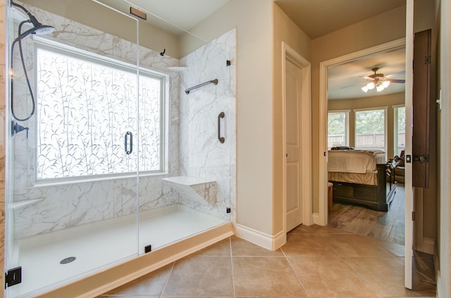 full bathroom with tile patterned floors, a marble finish shower, a ceiling fan, and ensuite bathroom