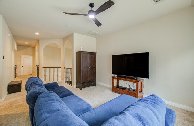 carpeted living room featuring ceiling fan