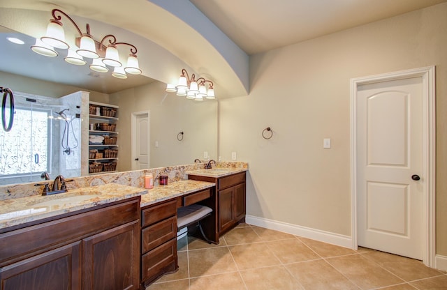 bathroom featuring vanity, tile patterned flooring, and a shower