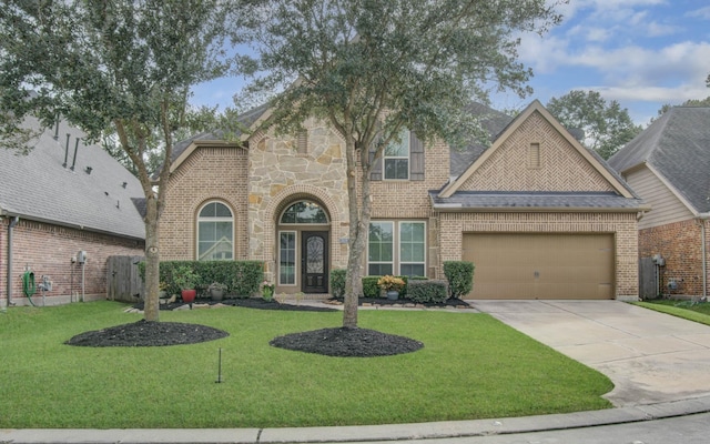 view of front facade with a garage and a front lawn