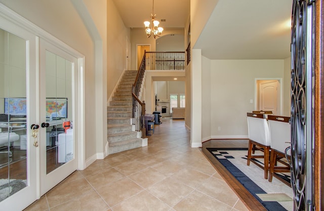 entryway with baseboards, stairs, light tile patterned floors, french doors, and a notable chandelier