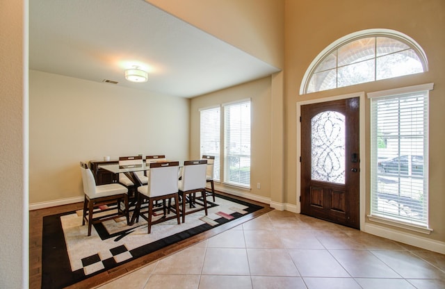 tiled entrance foyer featuring visible vents and baseboards