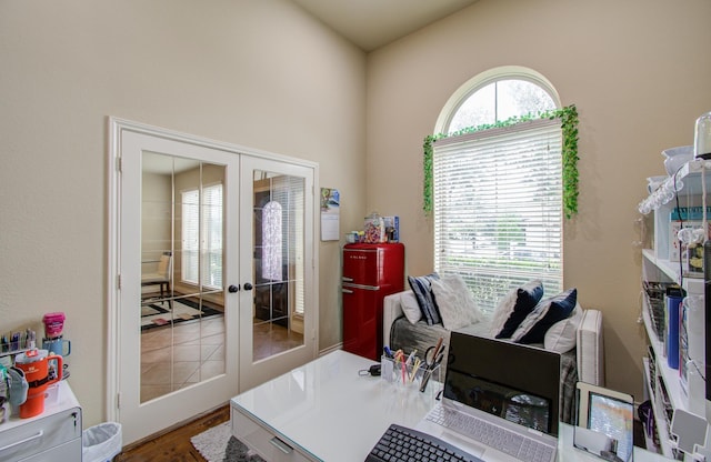 office with hardwood / wood-style flooring and french doors