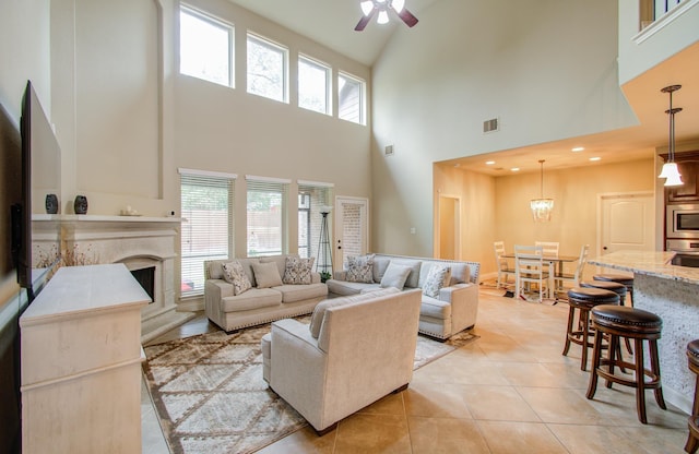 living room featuring visible vents, a ceiling fan, light tile patterned flooring, a fireplace, and recessed lighting