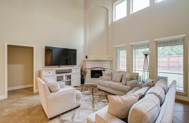 tiled living room with a towering ceiling