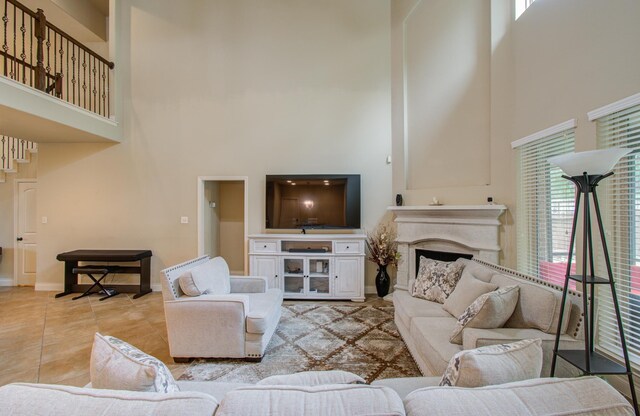 tiled living room with a towering ceiling