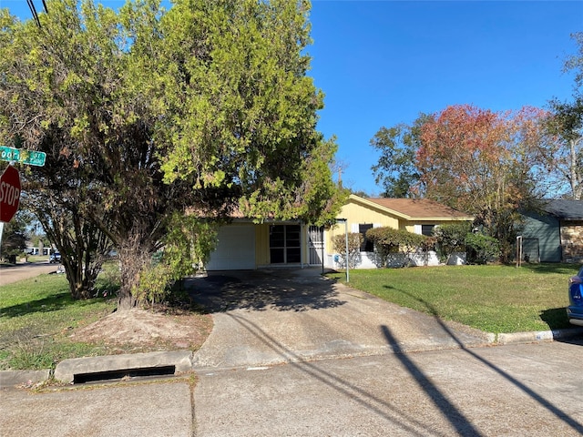 view of front of property featuring a garage and a front lawn