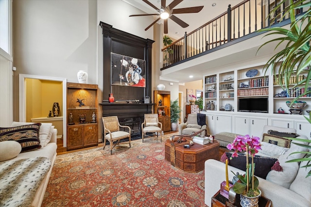 living room featuring a towering ceiling and ceiling fan