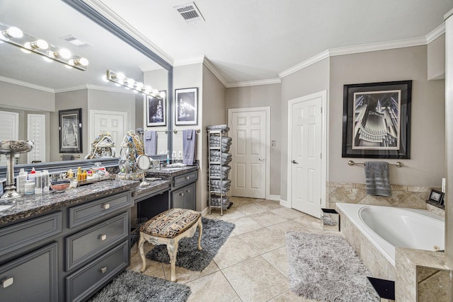 bathroom with ornamental molding, vanity, tile patterned flooring, and tiled tub