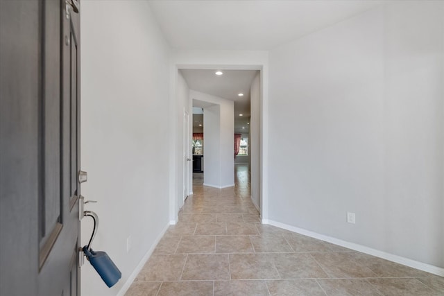 hallway featuring light tile patterned flooring