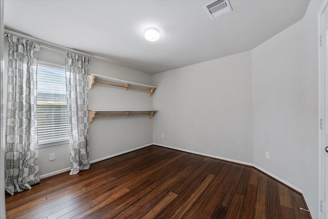 spare room featuring dark wood-type flooring