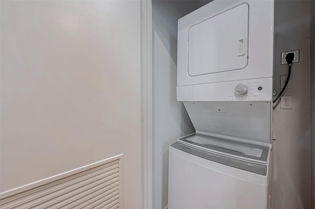 clothes washing area with stacked washer / drying machine