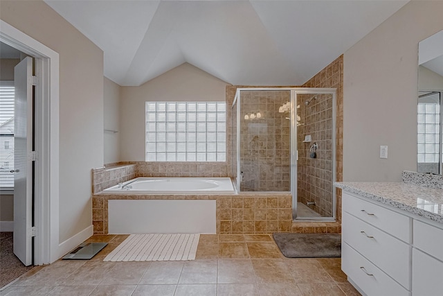 bathroom featuring vanity, tile patterned floors, lofted ceiling, and separate shower and tub