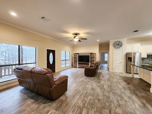 living room featuring ceiling fan, a healthy amount of sunlight, and wood-type flooring