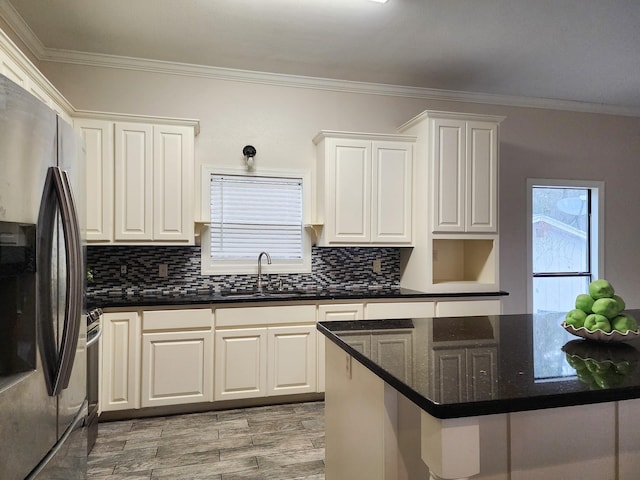 kitchen with stainless steel appliances, sink, decorative backsplash, and white cabinets