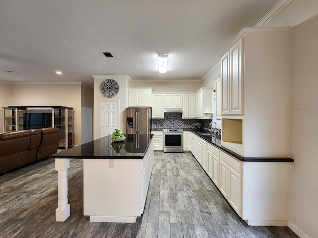 kitchen featuring white cabinetry, a center island, dark hardwood / wood-style flooring, stainless steel appliances, and decorative backsplash