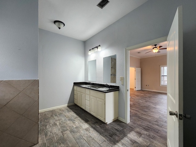 bathroom with wood-type flooring, ceiling fan, vanity, and crown molding