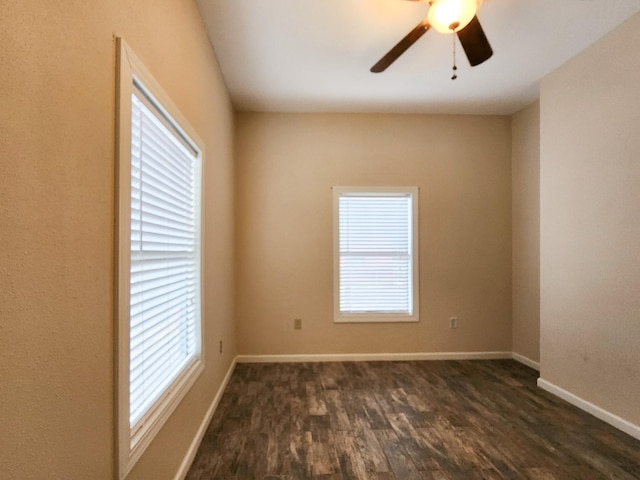 spare room with ceiling fan, a healthy amount of sunlight, and dark hardwood / wood-style floors