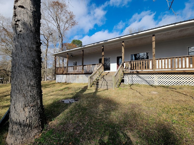 view of front facade with ceiling fan and a front lawn