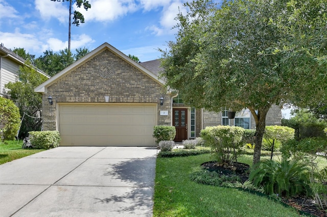 view of front facade with a garage and a front lawn