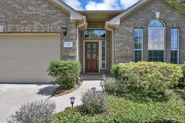 view of exterior entry with a garage