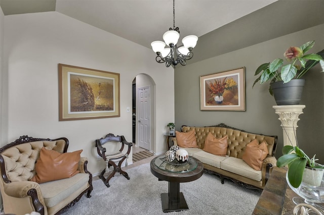 living room with an inviting chandelier and vaulted ceiling