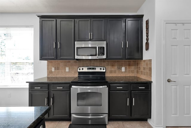 kitchen featuring tasteful backsplash, stainless steel appliances, and light tile patterned flooring