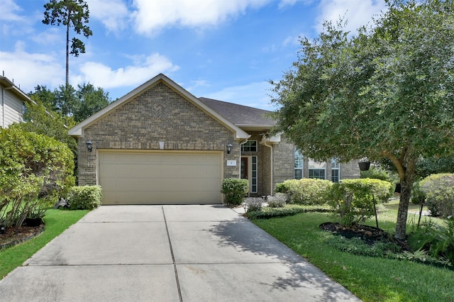 view of front of house with a garage and a front lawn