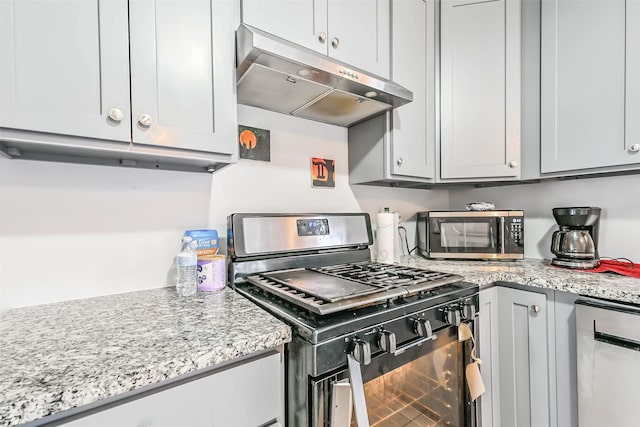 kitchen featuring stainless steel appliances and light stone countertops