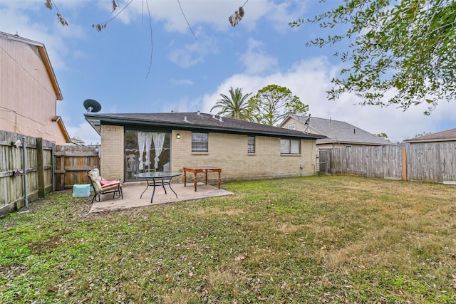 back of property with a lawn and a patio