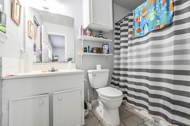 bathroom with tile patterned floors, toilet, and vanity