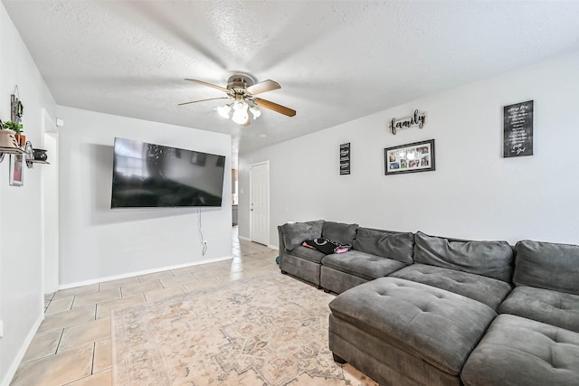 tiled living room with ceiling fan and a textured ceiling