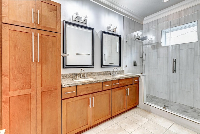 bathroom featuring tile patterned flooring, ornamental molding, vanity, and a shower with shower door