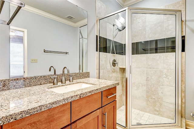 bathroom featuring ornamental molding, an enclosed shower, and vanity