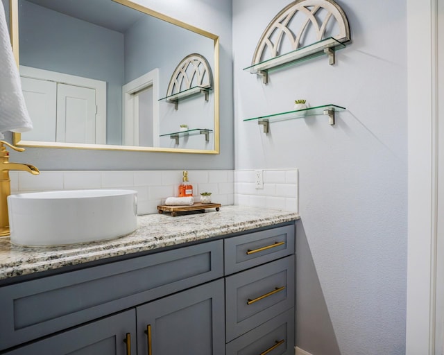 bathroom featuring vanity and decorative backsplash