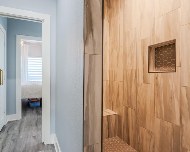 bathroom with wood-type flooring and walk in shower