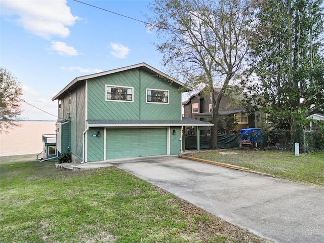 view of front of property featuring a yard and a garage