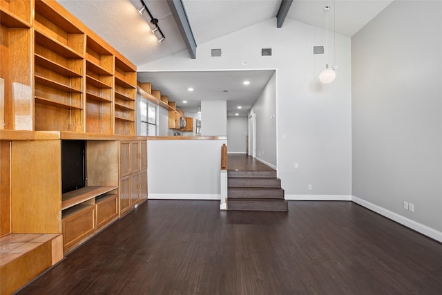 unfurnished living room with track lighting, dark hardwood / wood-style flooring, lofted ceiling with beams, and a textured ceiling