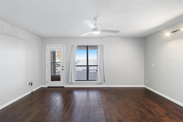 unfurnished room featuring dark hardwood / wood-style floors, a textured ceiling, and ceiling fan