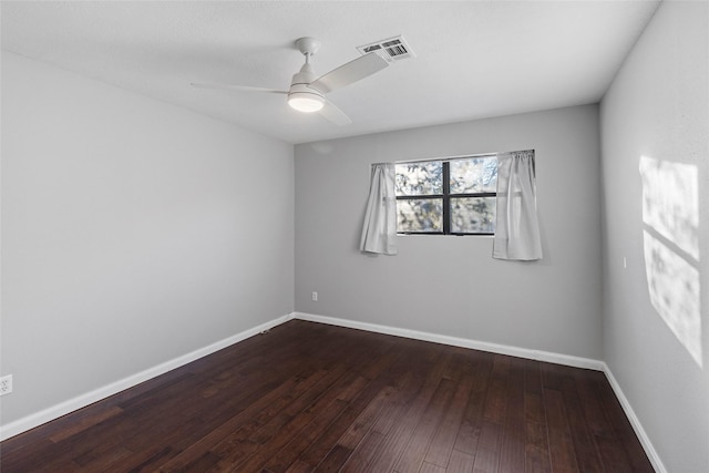 empty room with ceiling fan and dark hardwood / wood-style floors