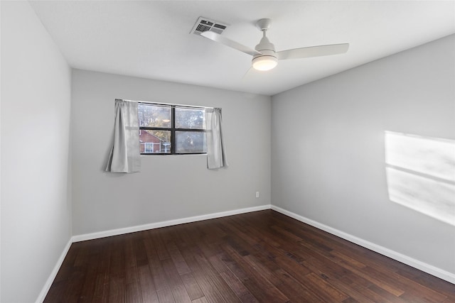 empty room featuring dark wood-type flooring and ceiling fan