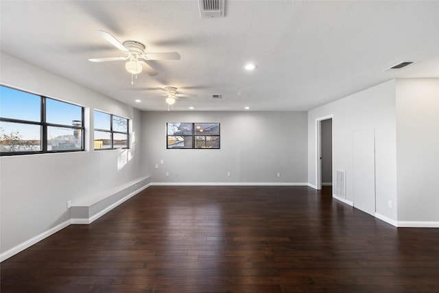 spare room featuring dark hardwood / wood-style floors and ceiling fan